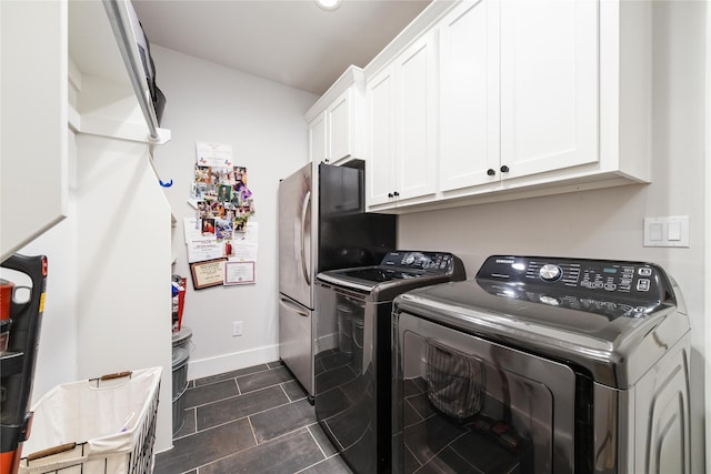 laundry room featuring cabinets and washer and clothes dryer