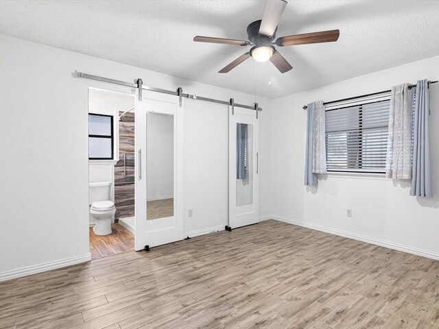 bathroom with vanity, toilet, and a textured ceiling