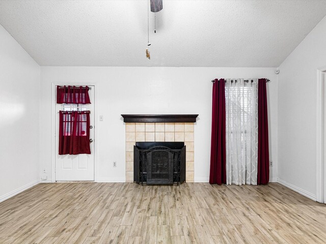 spare room with ceiling fan, a textured ceiling, and light hardwood / wood-style floors