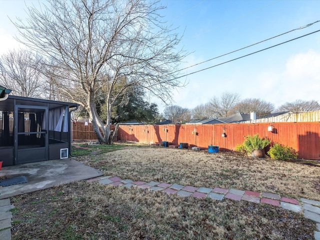 view of yard featuring a patio area and a sunroom