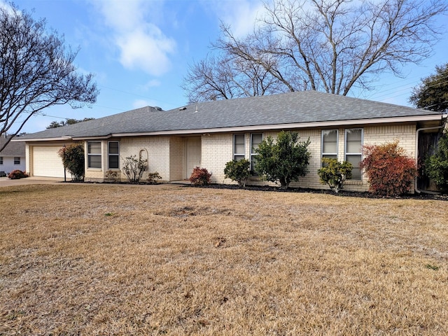 ranch-style house with a garage and a front yard