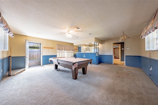 game room featuring carpet, a healthy amount of sunlight, and wainscoting