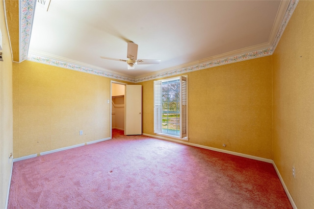 carpeted spare room with baseboards, ornamental molding, and ceiling fan