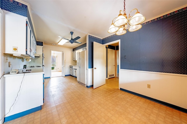 kitchen featuring light floors, a wainscoted wall, white cabinetry, light countertops, and white fridge with ice dispenser