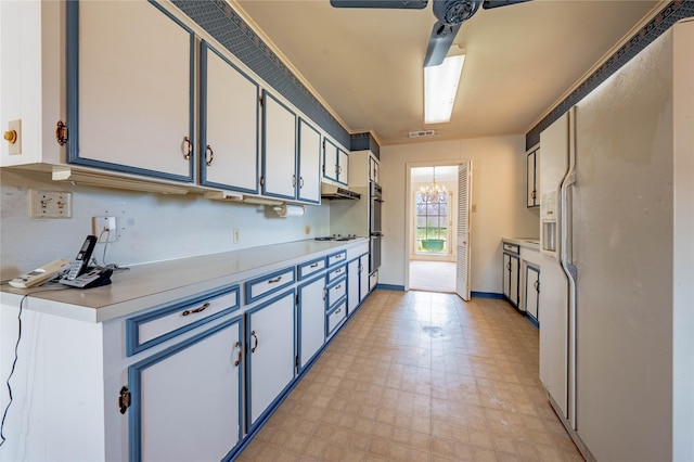 kitchen with under cabinet range hood, white appliances, white cabinets, light countertops, and light floors