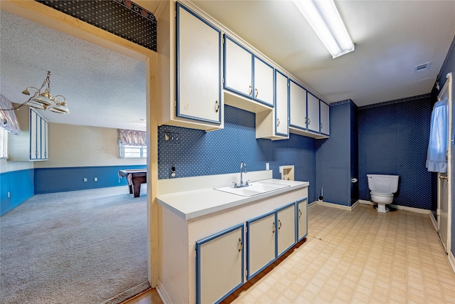 kitchen with pool table, a sink, visible vents, light countertops, and light floors