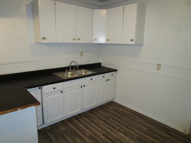 kitchen with white cabinetry, sink, and dark hardwood / wood-style floors