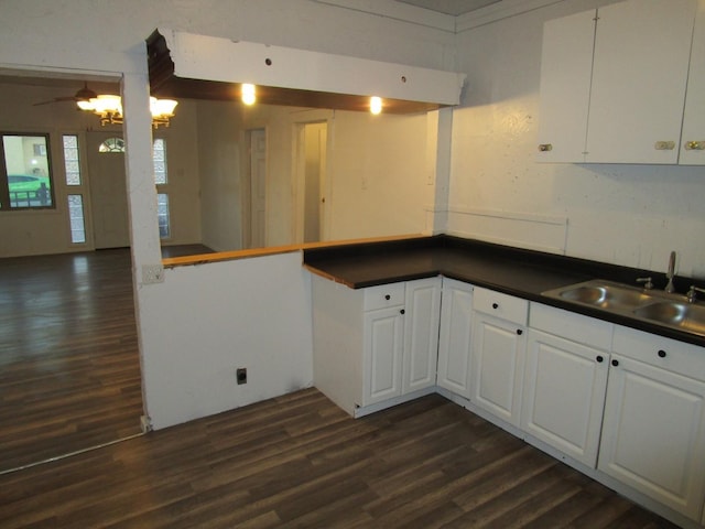 kitchen featuring sink, dark wood-type flooring, and white cabinets