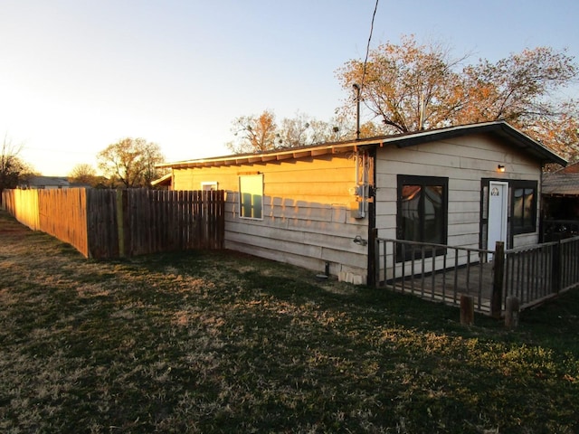 property exterior at dusk with a yard