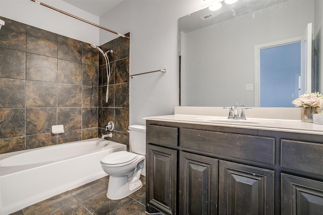 3503 Blue Sage Ln, Garland, TX 75040 - full bath featuring vanity, toilet, visible vents, stone finish flooring, and washtub / shower combination