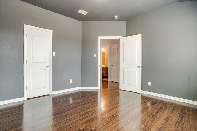 spare room with dark hardwood / wood-style floors