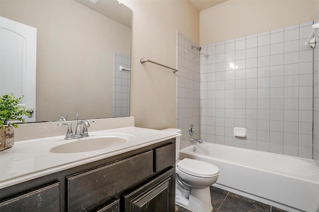 full bathroom with tiled shower / bath, vanity, and toilet