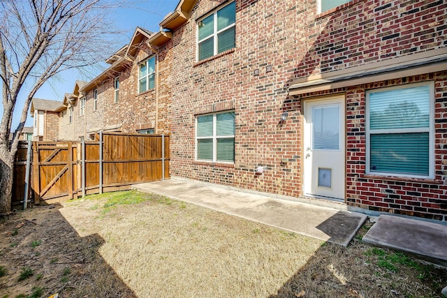 3503 Blue Sage Ln, Garland, TX 75040 - rear view of property with brick siding, a gate, fence, and a patio