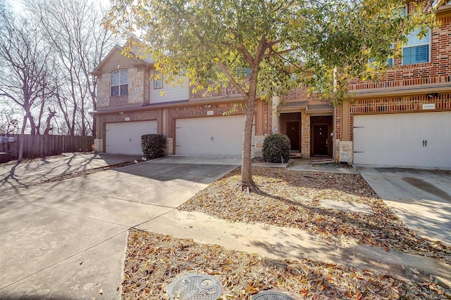 3503 Blue Sage Ln, Garland, TX 75040 - view of front facade featuring fence, driveway, brick siding, and a garage
