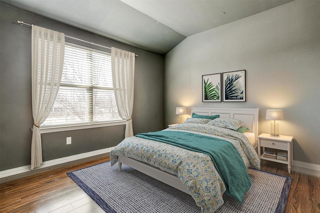 bedroom featuring lofted ceiling and hardwood / wood-style flooring