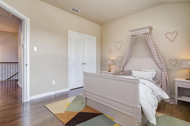 3503 Blue Sage Ln, Garland, TX 75040 - bedroom with wood finished floors, a closet, baseboards, lofted ceiling, and visible vents