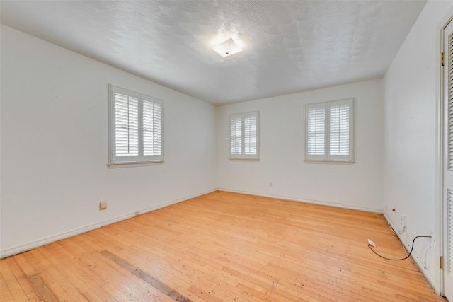 unfurnished room with light hardwood / wood-style flooring