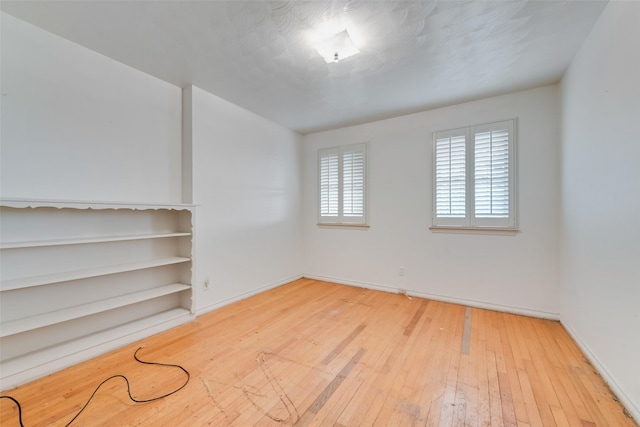 spare room with light hardwood / wood-style flooring