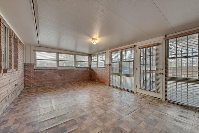 unfurnished sunroom featuring a healthy amount of sunlight