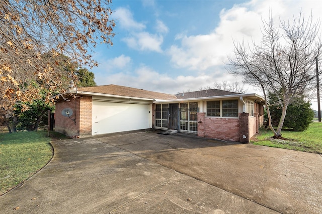 ranch-style house featuring a garage and a front yard