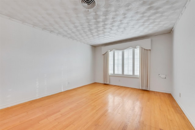 spare room featuring light hardwood / wood-style floors