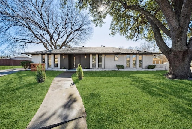 ranch-style home with a front lawn