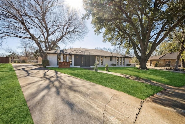 ranch-style house with a front lawn