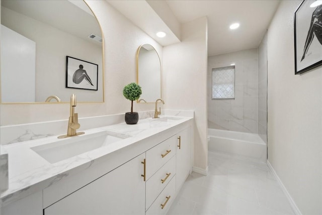 bathroom featuring vanity and tiled shower / bath combo