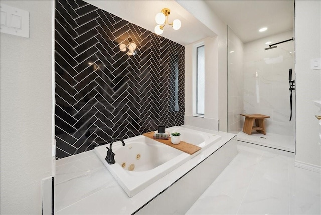 bathroom featuring tile walls and separate shower and tub