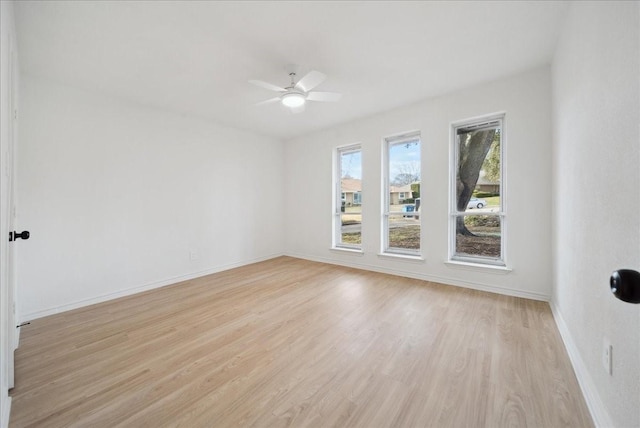 empty room with ceiling fan and light wood-type flooring