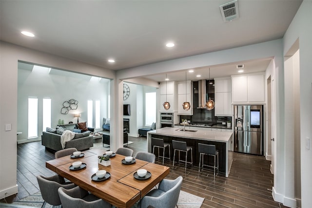 dining area with wood finish floors, visible vents, baseboards, and recessed lighting