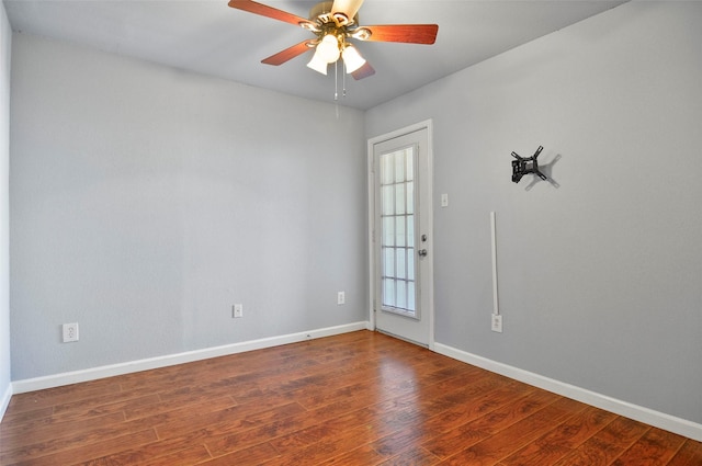 spare room featuring dark hardwood / wood-style floors and ceiling fan