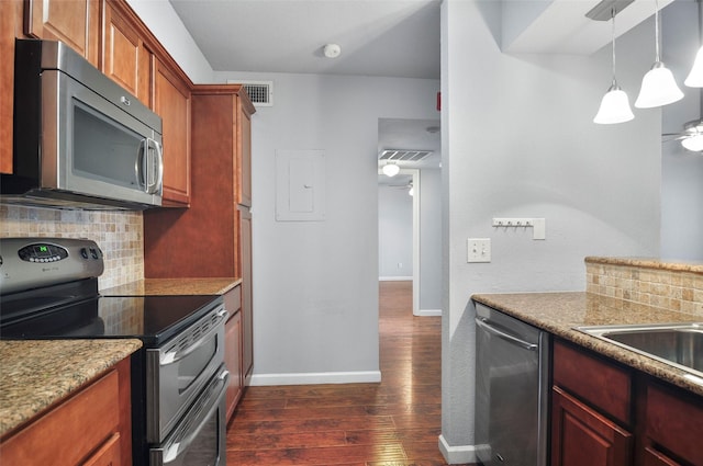 kitchen featuring dark hardwood / wood-style floors, decorative light fixtures, decorative backsplash, ceiling fan, and stainless steel appliances