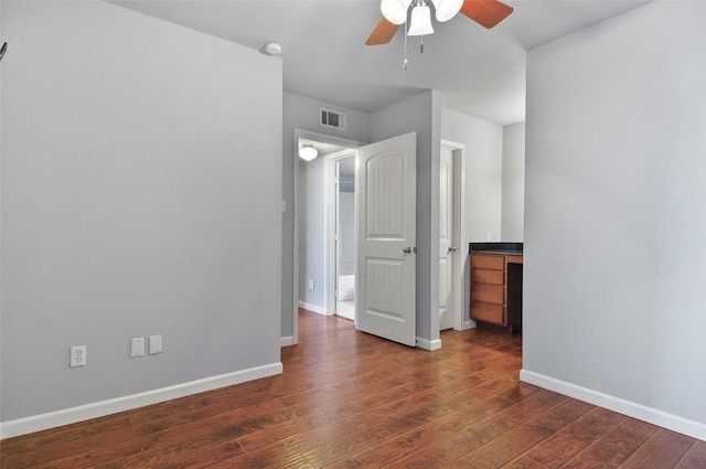 empty room featuring dark hardwood / wood-style floors and ceiling fan