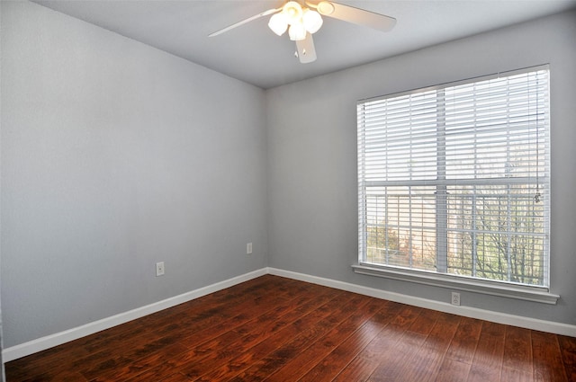 empty room with ceiling fan and dark hardwood / wood-style floors