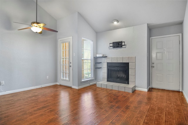 unfurnished living room with lofted ceiling, hardwood / wood-style floors, a fireplace, and ceiling fan