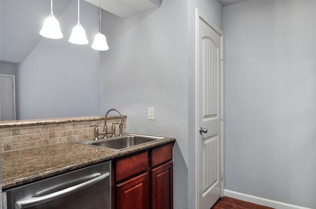 kitchen with dark hardwood / wood-style flooring, dishwasher, sink, and hanging light fixtures