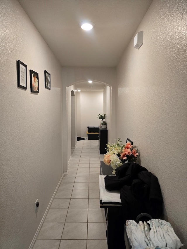 hallway featuring light tile patterned flooring