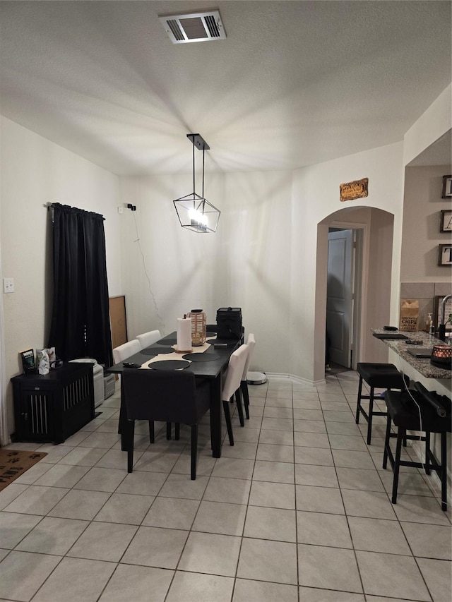 dining area featuring light tile patterned flooring