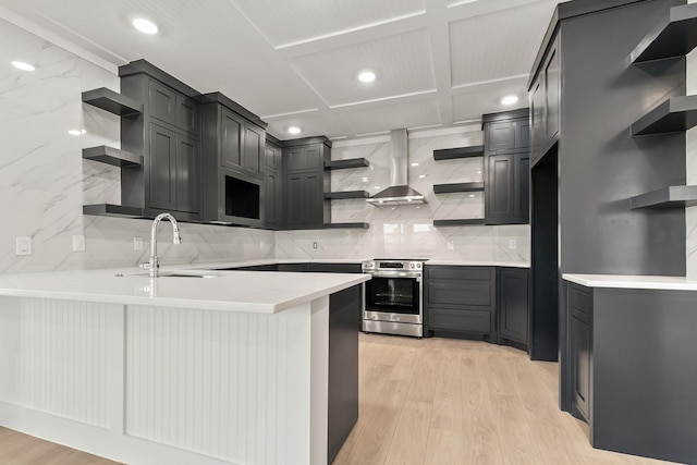 kitchen with sink, light hardwood / wood-style flooring, stainless steel range with electric cooktop, and exhaust hood