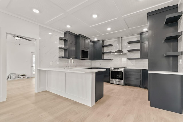 kitchen featuring electric stove, backsplash, light hardwood / wood-style floors, kitchen peninsula, and wall chimney exhaust hood