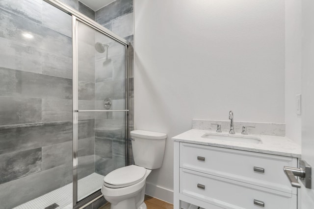 bathroom with vanity, hardwood / wood-style flooring, toilet, and walk in shower