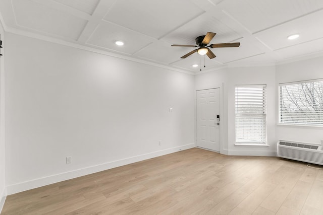 spare room featuring coffered ceiling, light hardwood / wood-style flooring, an AC wall unit, ceiling fan, and beam ceiling