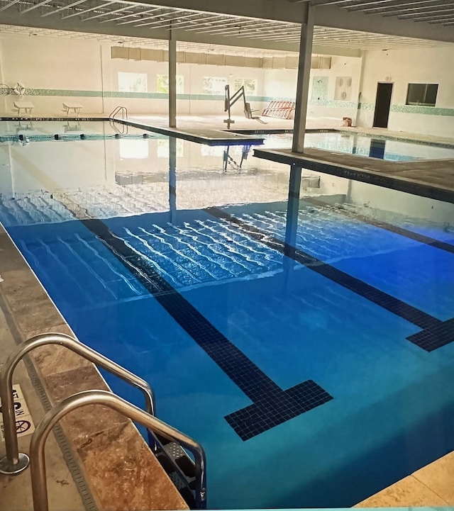 view of pool with a hot tub