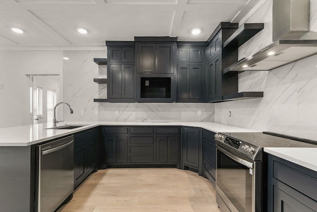 kitchen featuring sink, appliances with stainless steel finishes, tasteful backsplash, kitchen peninsula, and wall chimney exhaust hood