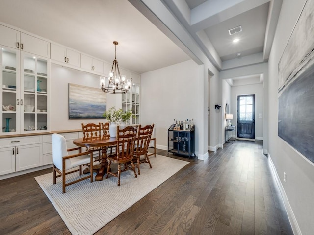 dining space featuring an inviting chandelier and dark hardwood / wood-style flooring