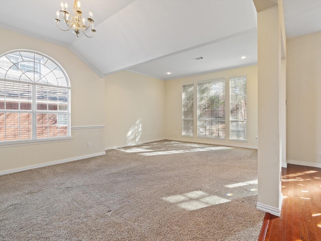 unfurnished living room with vaulted ceiling, carpet, and a chandelier