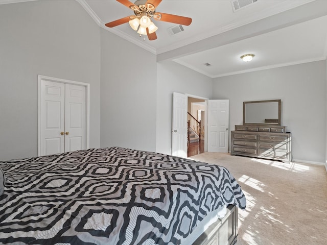 bedroom featuring ornamental molding, carpet flooring, a closet, a towering ceiling, and ceiling fan