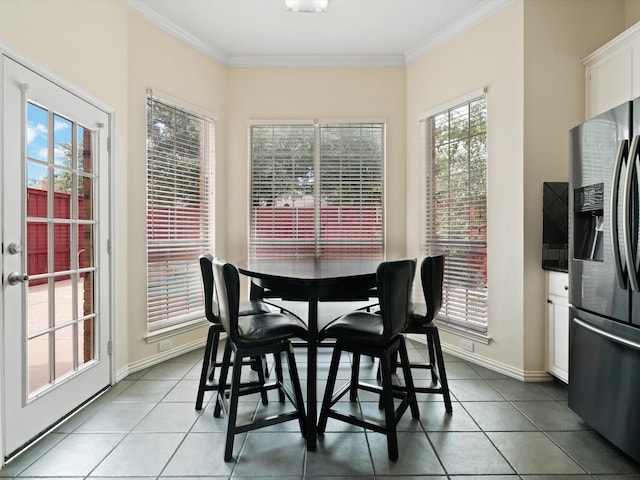 dining space featuring tile patterned flooring and crown molding