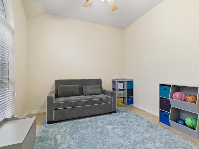 living area with lofted ceiling, carpet, and ceiling fan